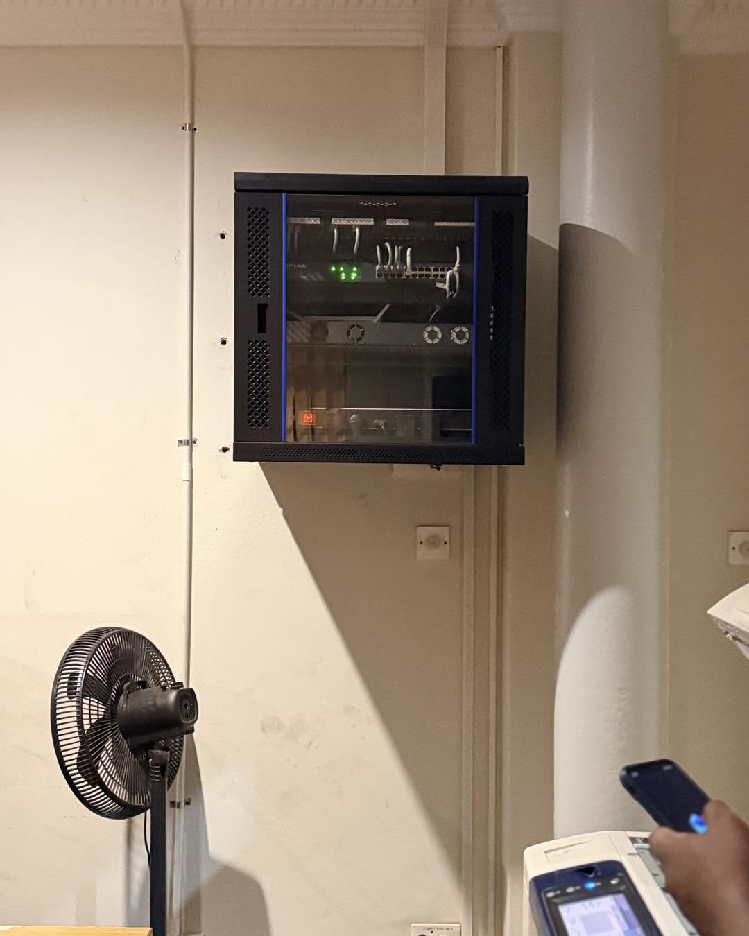 Completed wall-mounted network cabinet installation