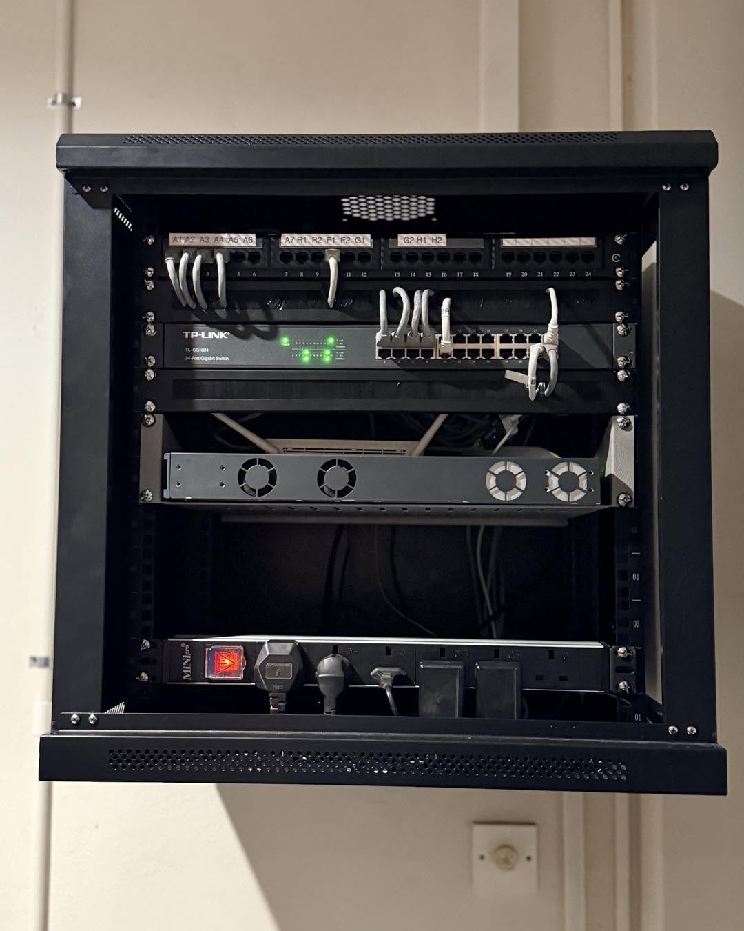 Organised network switch and structured cabling inside a network cabinet